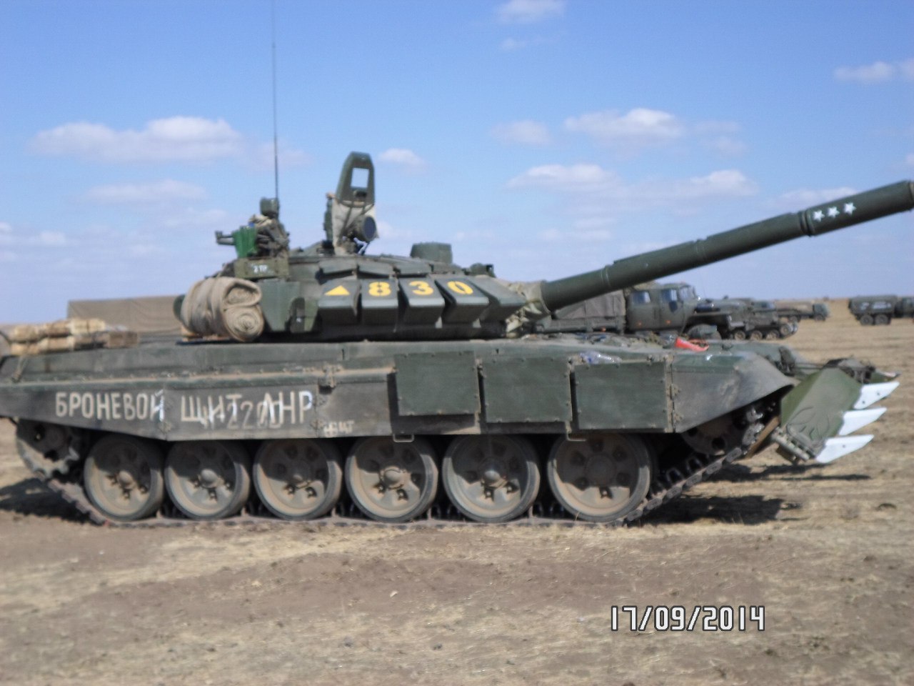 T-72B3 tank numbered 830 with the inscription "ARMORED SHIELD OF THE LNR" on the right side. Archive / Original