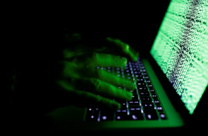 A man types on a computer keyboard in front of the displayed cyber code in this illustration picture taken on March 1, 2017.REUTERS/Kacper Pempel/Illustration