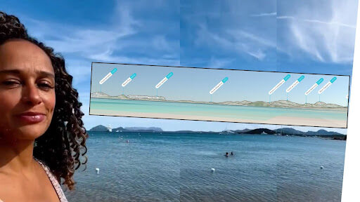 An image of dos Santos at a beach in Sardinia with PeakVisor image showing mountains behind her.