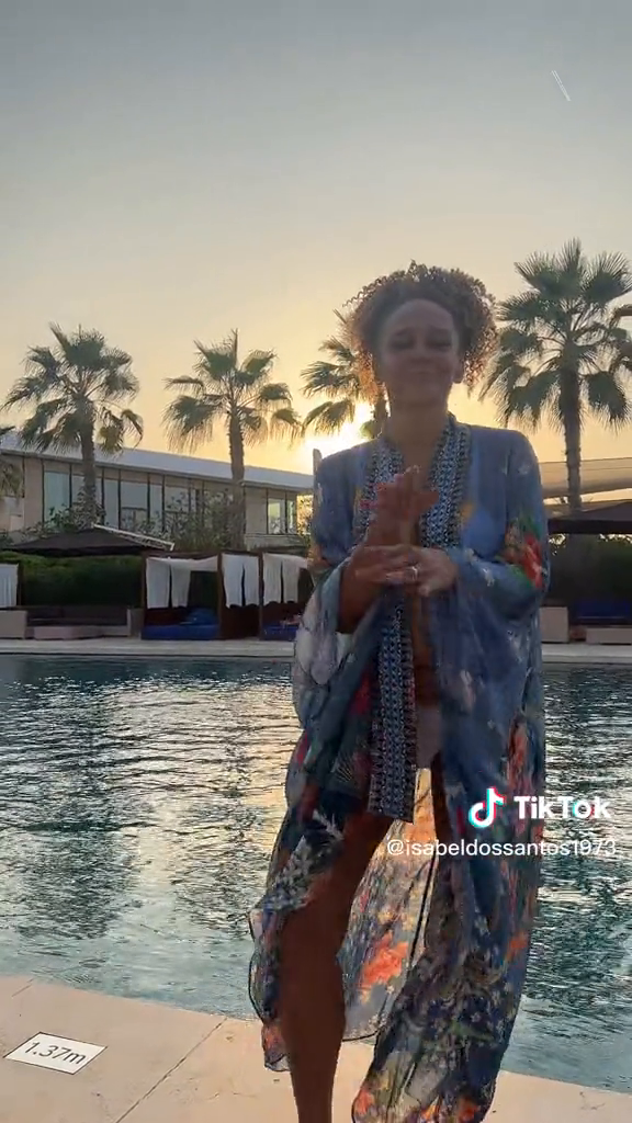 Image of Isabel dos Santos besides a pool at a resort.